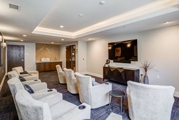 A living room with couches and chairs and a tv